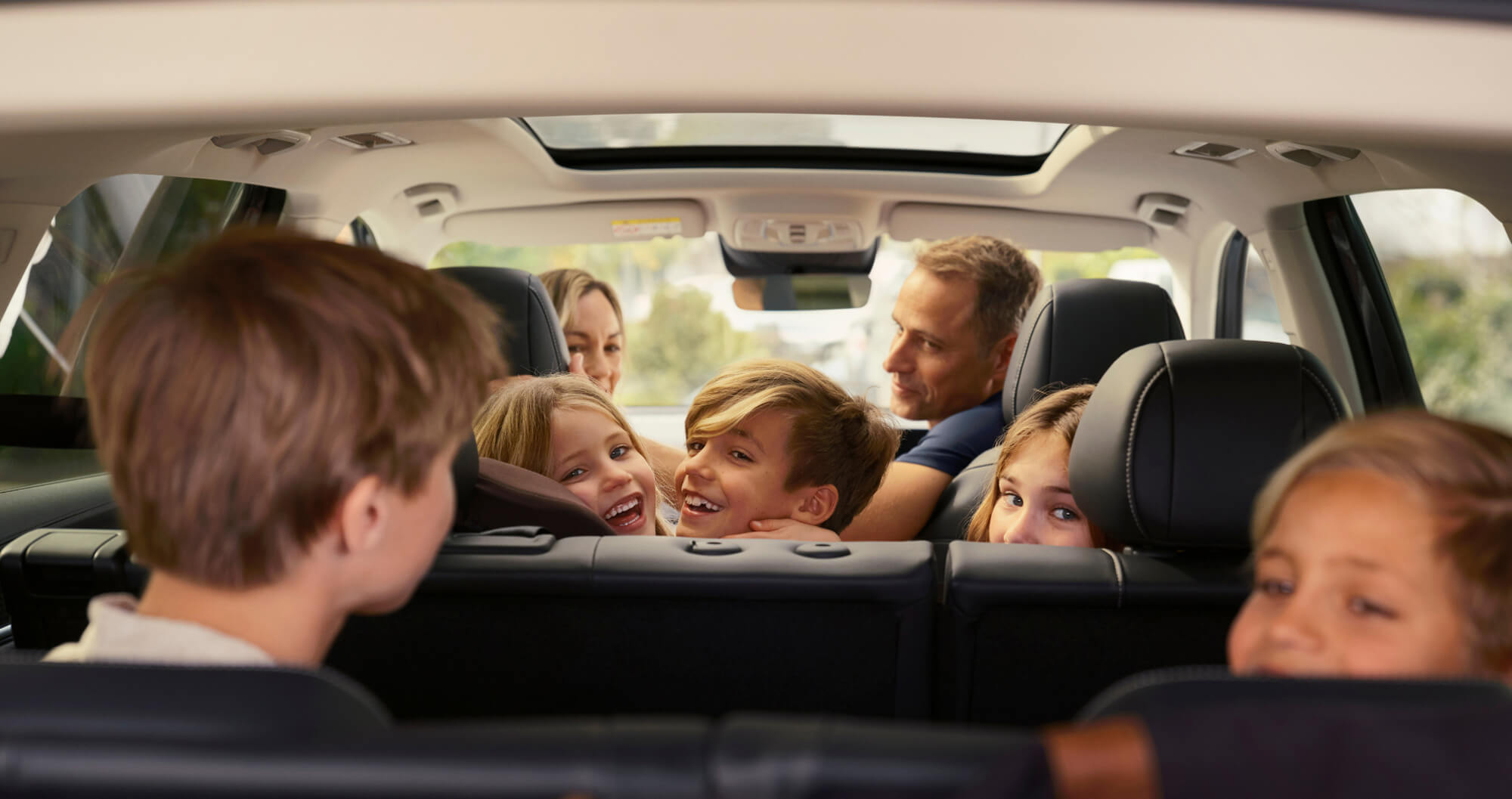 Family smiling inside MG QS